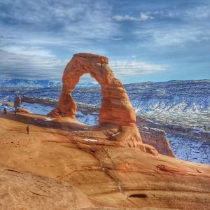 Delicate Arch in Moab, Utah, showcased against a winter landscape. Perfect for travel and nature enthusiasts.